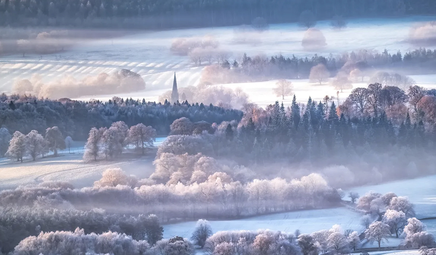 frosty European landscape, trees, church, fields